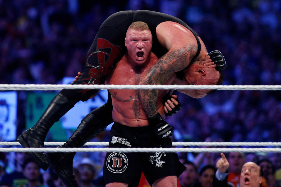 The Undertaker, top, and Brock Lesnar, bottom, compete during Wrestlemania XXX at the Mercedes-Benz Super Dome in New Orleans on Sunday, April 6, 2014. (Jonathan Bachman/AP Images for WWE)
