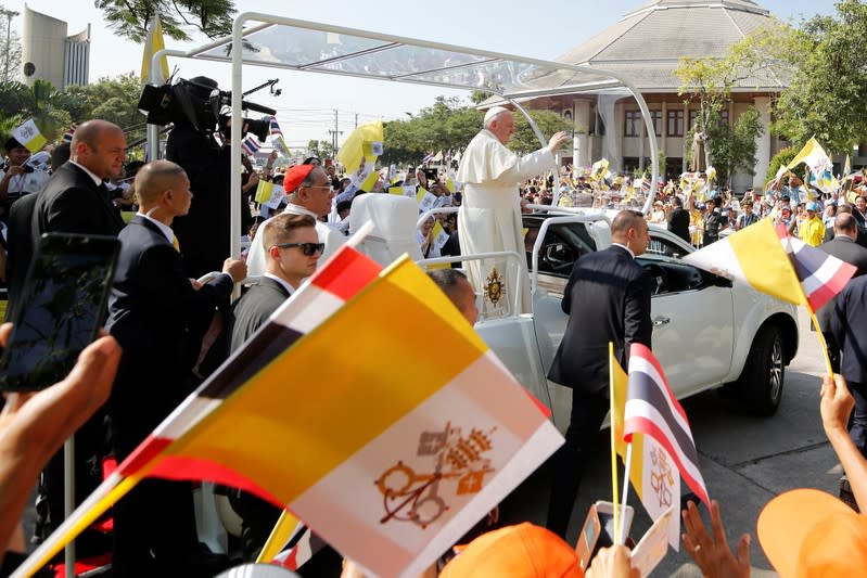 Pope Francis waves to the crowd following his visit to St. Peter's Parish church in the Sam Phran district of Nakhon Pathom Province