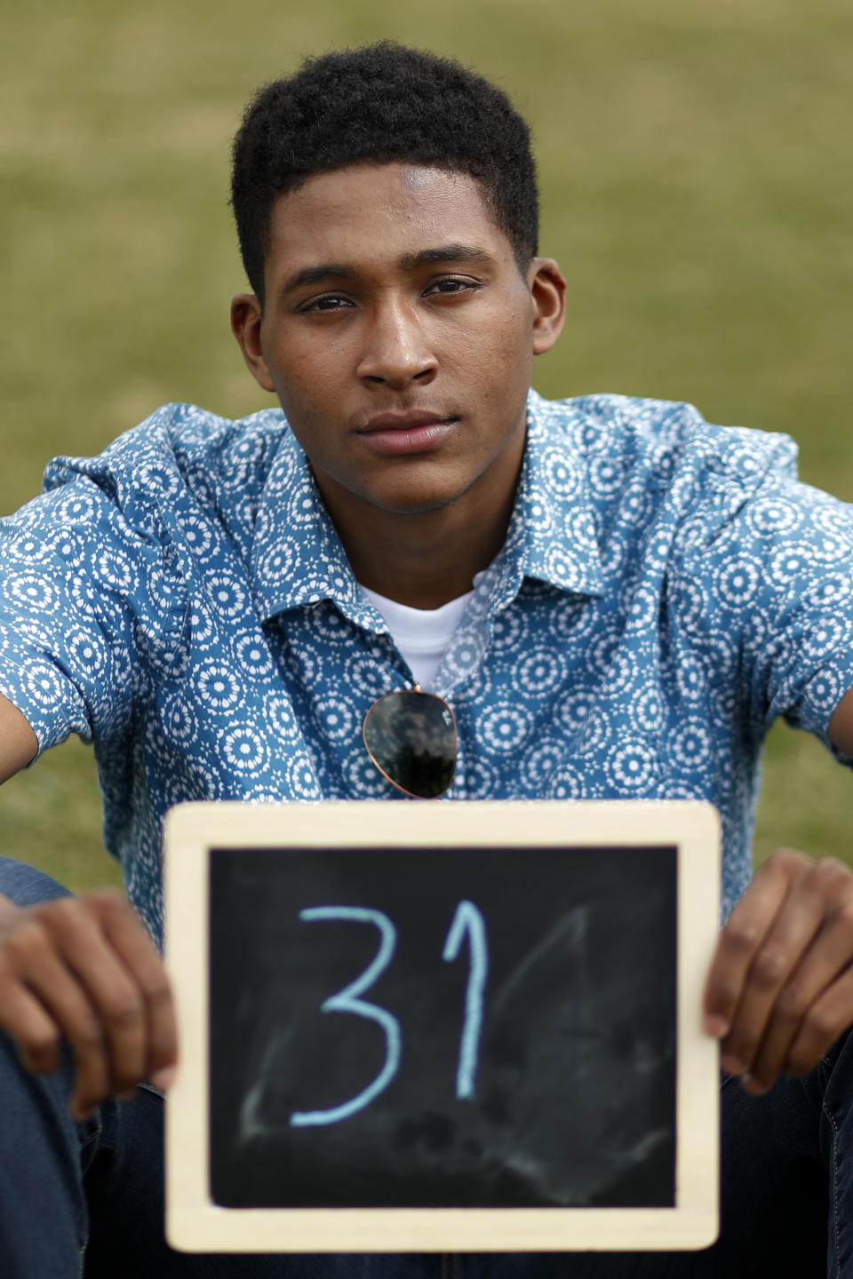 Cole Hepburn, 20, of Montclair, N.J., poses for a portrait with a chalkboard of his age in 2030, the point where the globe would be stuck on a path toward what scientists call planet-changing dangerous warming, Friday, March 15, 2019, during a climate change rally of students in Washington. "It's our generation that's making the change and I feel like I should be a part of it and that it's very important," says the college student who is visiting Washington on his spring break, "it's hard for adults to change and us young people already have our minds set to improve while the old generation is afraid of change." From the South Pacific to the edge of the Arctic Circle, students are skipping classes to protest what they see as the failures of their governments to take tough action against global warming. The 'school strikes' on Friday were inspired by 16-year-old Swedish activist Greta Thunberg and are taking place in over 100 countries. (AP Photo/Jacquelyn Martin)