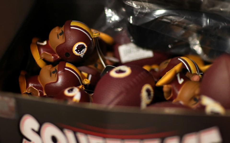 Redskins branded merchandise sits on display in a sports store  - REUTERS