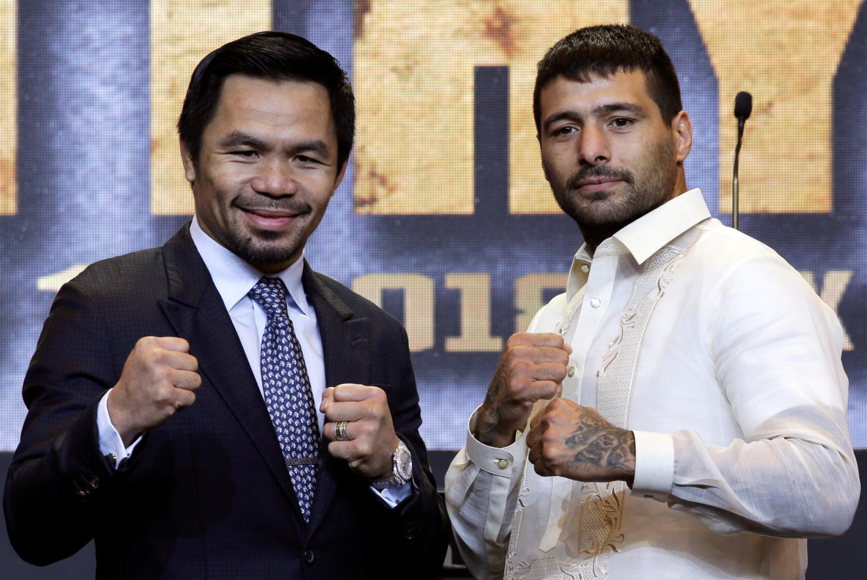 Philippine senator and boxing hero Manny Pacquiao, left, and Argentine WBA welterweight champion Lucas Matthysse pose for photographers during a press conference in Manila, Philippines on Wednesday, April 18, 2018. The two are scheduled to fight on July 15, in a World Boxing Association welterweight title fight in Malaysia. (AP Photo/Aaron Favila)