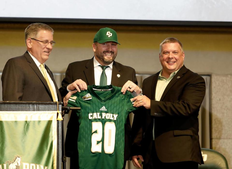 Cal Poly officially announced Beau Baldwin as its new head football coach on Wednesday, Dec. 11, 2019. Baldwin holds up a Cal Poly jersey with President Jeffrey Armstrong, left, and Athletic Director Don Oberhelman.