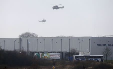 Helicopters with French intervention forces hover above the scene of a hostage taking at an industrial zone in Dammartin-en-Goele, northeast of Paris January 9, 2015. REUTERS/Pascal Rossignol