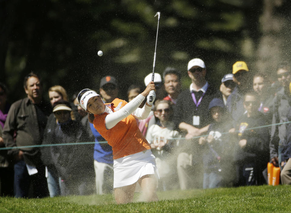 Jenny Shin hits out of a fairway bunker on the sixth hole of Lake Merced Golf Club during the final round of the Swinging Skirts LPGA Classic golf tournament on Sunday, April 27, 2014, in Daly City, Calif. Her shot went straight up and landed back in the bunker. (AP Photo/Eric Risberg)