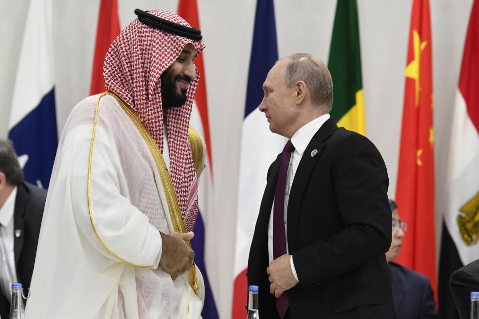 FILE - Saudi Arabia's Crown Prince Mohammed bin Salman and Russian President Vladimir Putin arrive for a working session of leaders at the G-20 summit in Osaka, Japan, on June 28, 2019. Putin has forged strong personal ties with Saudi Crown Prince Mohammed bin Salman, helping strike an OPEC+ deal to cut oil output. (AP Photo/Susan Walsh, File)