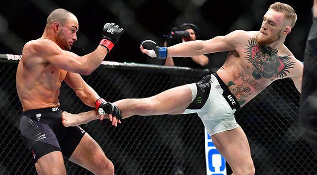 McGregor became the first person in the history of the UFC to hold two title belts at the same time after his win over Eddie Alvarez. Photo: AAP