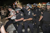 FILE - In this May 30, 2020, file photo, police scuffle with protesters in the Brooklyn borough of New York. Two civil rights organizations are suing the New York Police Department on behalf of protesters who say they were roughed up by officers because they expressed anti-police views during nightly demonstrations in the spring in the wake of George Floyd's killing. (AP Photo/Seth Wenig, File)