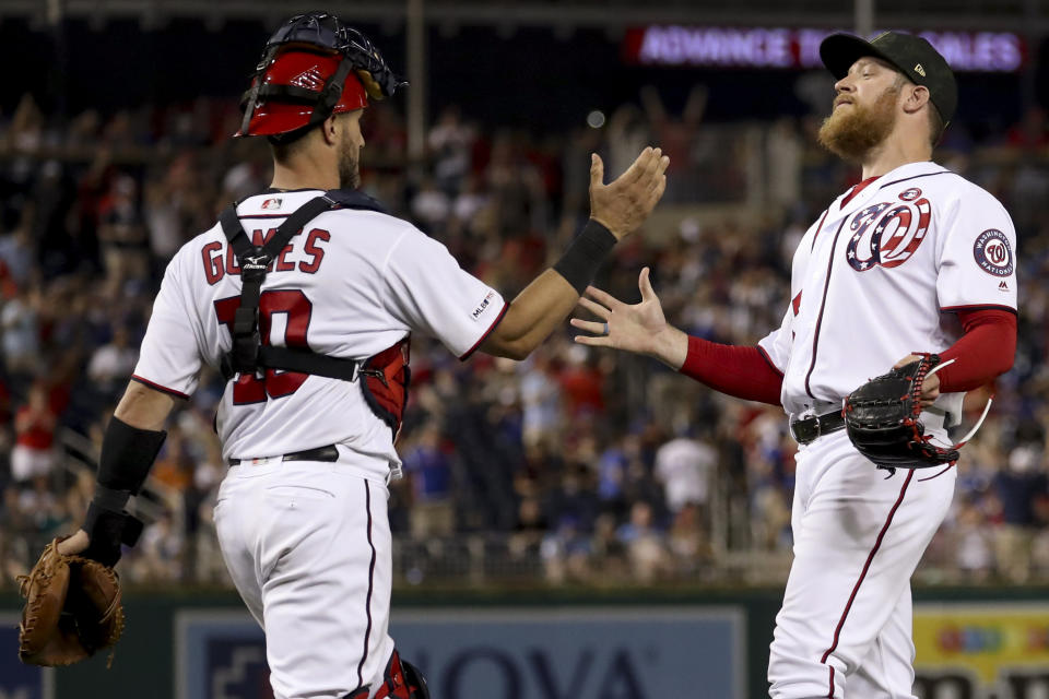 Washington Nationals catcher Yan Gomes (10) and Washington Nationals relief pitcher Sean Doolittle, right, celebrate after the Nationals defeated the Chicago Cubs 5-2 in a baseball game Saturday, May 18, 2019, in Washington. (AP Photo/Andrew Harnik)