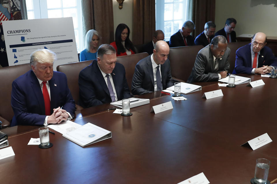 Housing and Urban Development Secretary Ben Carson, second from the right, bows his head to lead a prayer before the start of the Cabinet meeting with from left, President Donald Trump, Secretary of State Mike Pompeo, Secretary of Labor Eugene Scalia, Carson, and Commerce Secretary Wilbur Ross, in the Cabinet Room of the White House, Monday, Oct. 21, 2019, in Washington. (AP Photo/Pablo Martinez Monsivais)