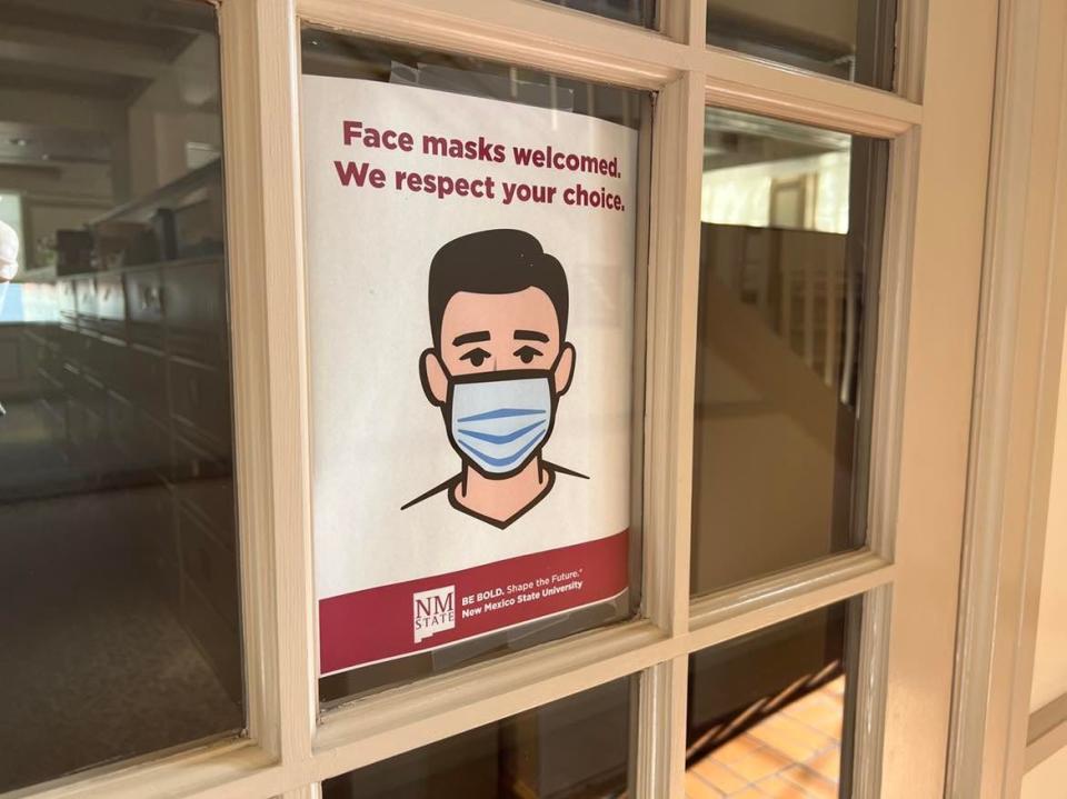 A sign posted at Dove Hall on New Mexico State University's main campus in Las Cruces says, "Face masks welcomed. We respect your choice," with no mention of COVID-19 disease or public health guidance, is pictured on Tuesday, May 3, 2022.