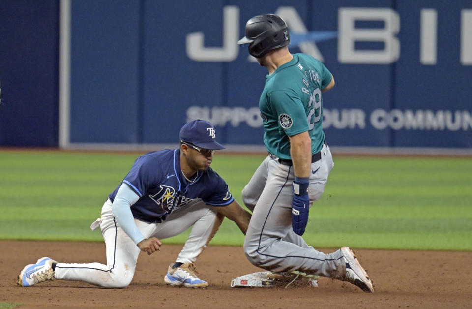 Seattle Mariners catcher Cal Raleigh (29) beats the tag from Tampa Bay Rays second baseman Richie Palacios for a stolen base during the sixth inning of a baseball game Monday, June 24, 2024, in St. Petersburg, Fla. (AP Photo/Steve Nesius)