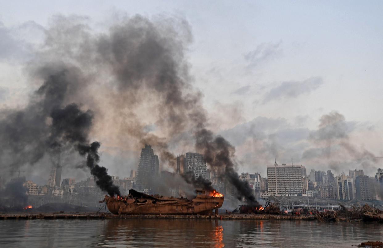 A ship in flames is pictured at the port of Beirut following a massive explosion on Tuesday: AFP via Getty Images