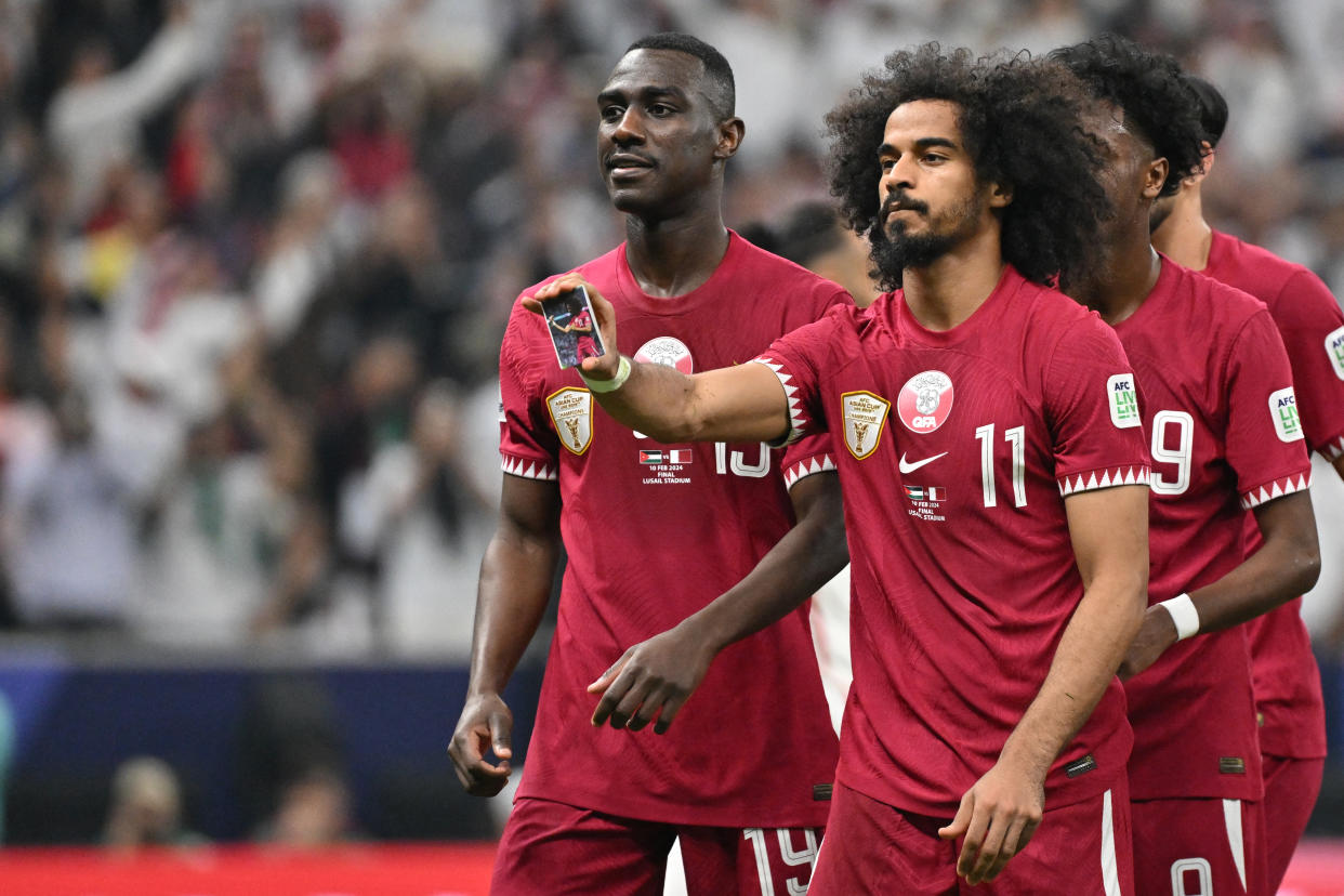 Qatar forward Akram Afif (11) celebrates after scoring a goal on a penalty during the AFC Qatar 2023 Asian Cup final. (Photo by HECTOR RETAMAL/AFP via Getty Images)
