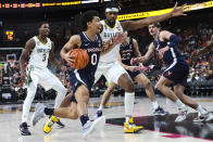 Virginia guard Kihei Clark (0) drives to the basket against Baylor forward Flo Thamba during the first half of an NCAA college basketball game Friday, Nov. 18, 2022, in Las Vegas. (AP Photo/Chase Stevens)