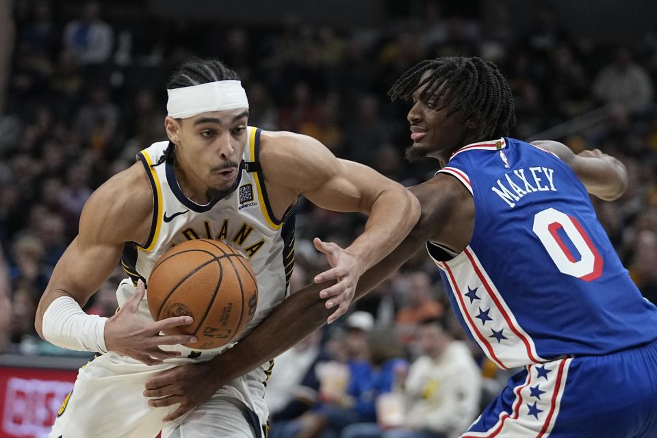 Indiana Pacers' Andrew Nembhard (2) goes to the basket against Philadelphia 76ers' Tyrese Maxey (0) during the second half of an NBA basketball game Thursday, Jan. 25, 2024, in Indianapolis. (AP Photo/Darron Cummings)