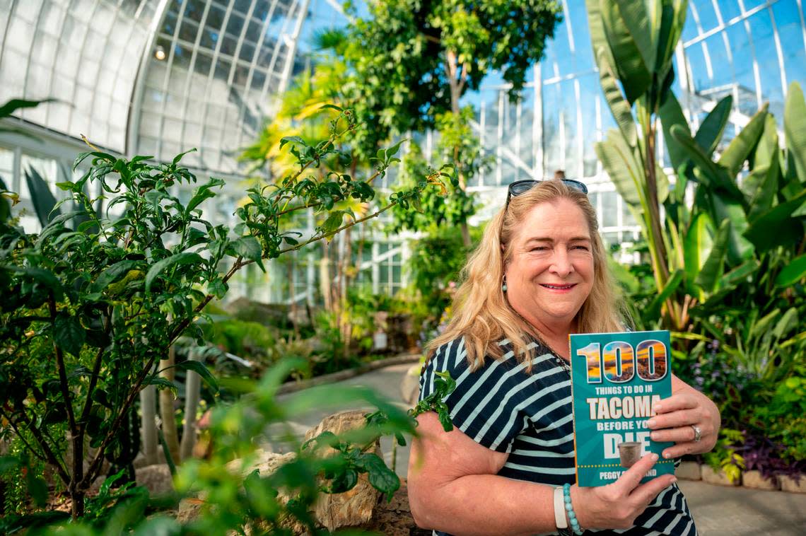Steilacoom resident and retired military officer Peggy Cleveland has moved 33 times in her life, but when her family landed in Tacoma, “It just felt like home,” she said. She stands in the remodeled W.W. Seymour Conservatory, No. 79 in the book, on Oct. 13.