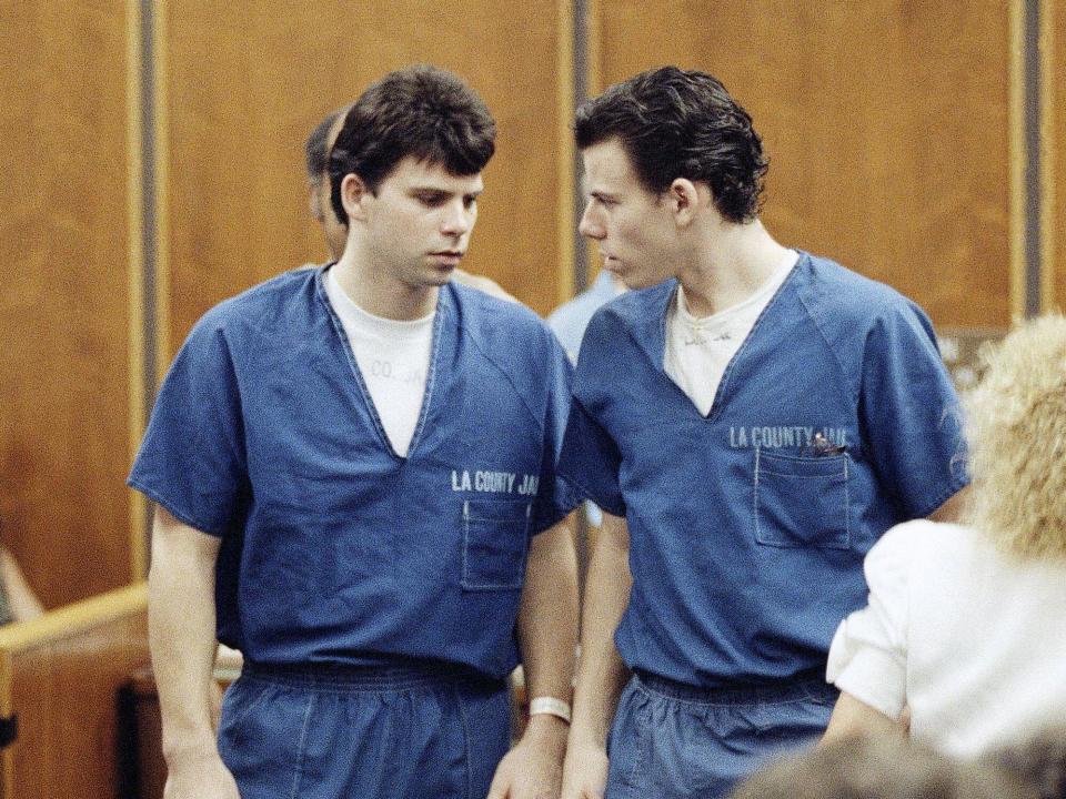 Lyle, left, and Erik Menendez leave courtroom in Santa Monica, Calif., Aug. 6, 1990, after a judge ruled that conversations between the two brothers and their psychologist after their parents were slain are not privileged and can be used as evidence in their murder case. (AP Photo/Nick Ut)