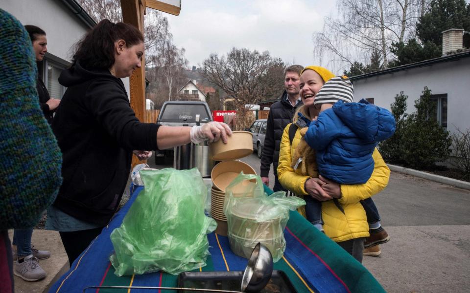 Ukrainian refugee Inna Ilinskaya sells goulash in Revnice village, near Prague - Michael Cizek/AFP