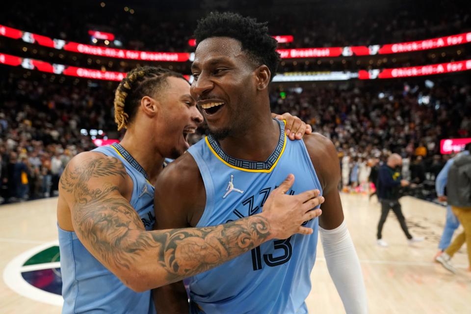 Memphis Grizzlies forwards Jaren Jackson Jr., right, and Brandon Clarke, left, celebrate after the team's NBA basketball game against the Utah Jazz on Monday, Nov. 22, 2021, in Salt Lake City. (AP Photo/Rick Bowmer)