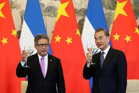 Chinese Foreign Minister Wang Yi and El Salvador's Foreign Minister Carlos Castaneda attend a signing ceremony to establish diplomatic ties between the two countries, at the Diaoyutai State Guesthouse in Beijing, China August 21, 2018. REUTERS/Jason Lee