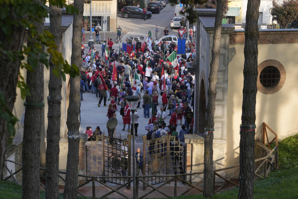 People gather during a march organized by the Italian Partisans association in Mussolini's birthplace Predappio Friday, Oct. 28, 2022, to mark the 78th anniversary of the liberation of the town from the nazi-fascist occupation by Italian Partisans and Polish allied troops, which coincides with the 100th anniversary of the march on Rome. (AP Photo/Luca Bruno)