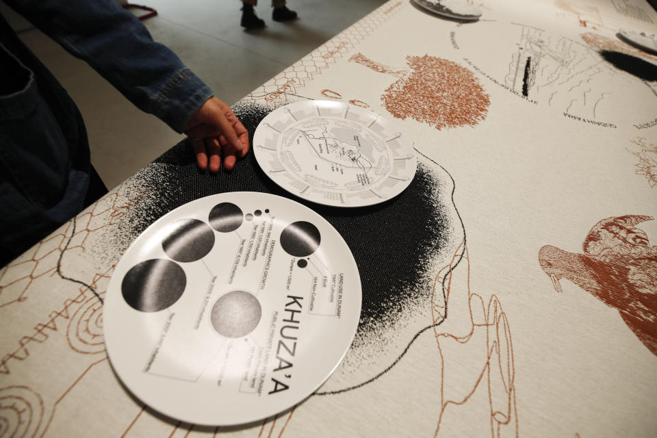 Malkit Shoshan, curator of the installation "Border Ecologies And The Gaza Strip" shows a detail of the installation during an interview with the Associated Press at a press preview of the exhibition "How will we live together?" of the Biennale International Architecture, in Venice, Italy, Wednesday, May 19, 2021. The 17th International Architecture Exhibition opens Saturday after a one-year pandemic delay, during which time architecture has emerged as one of the key disciplines in the global coronavirus response. (AP Photo/Alessandra Tarantino)