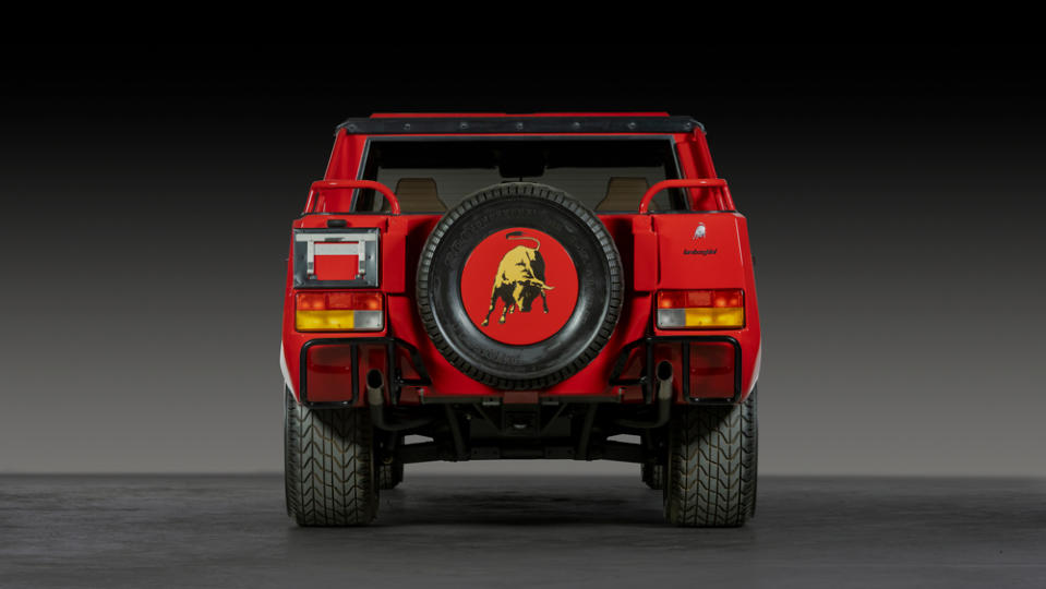 The back of a red 1991 Lamborghini LM002.