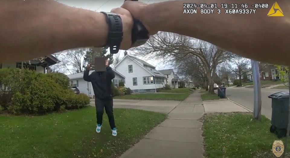 In this screen grab, the fake gun carried by Tavion Koonce-Williams can be seen a moment before he was shot in the hand by Akron Police Officer Ryan Westlake.