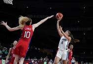 France's Marine Fauthoux (4) shoots over United States' Breanna Stewart (10) during women's basketball preliminary round game at the 2020 Summer Olympics, Monday, Aug. 2, 2021, in Saitama, Japan. (AP Photo/Charlie Neibergall)