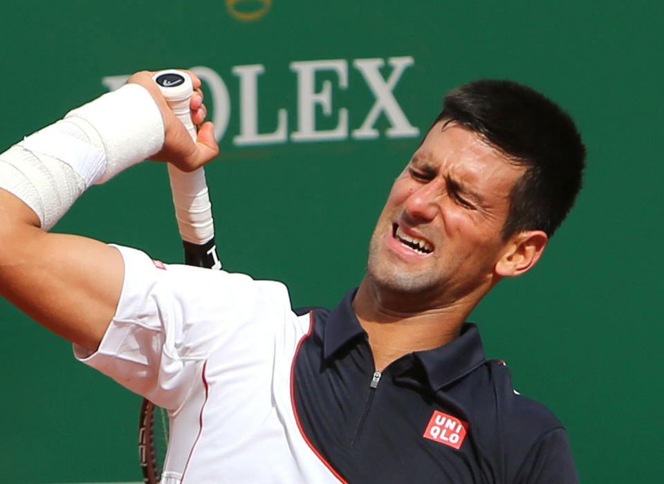 Novak Djokovic of Serbia reacts after losing a point against Roger Federer of Switzerland, during their semifinal match of the Monte Carlo Tennis Masters tournament, in Monaco, Saturday, April, 19, 2014. Federer won 7-6, 6-2. (AP Photo/Claude Paris)