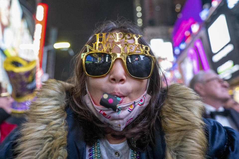 NEW YORK, NEW YORK - JANUARY 01: A girl blows a noisemaker and celebrates New Year’s Eve in Times Square on January 01, 2022 in New York City. Despite a surge in COVID-19 cases New Year’s Eve happened as planed but with only 15,000 vaccinated participants allowed, who were also required to be masked at all times. In an effort to increase safety, people were initially only allowed in beginning at 3 p.m. on the day of, but were let in earlier. People will also be spread out in socially-distanced pens. Last year’s celebration allowed no spectators due to the coronavirus pandemic. (Photo by Alexi Rosenfeld/ Getty Images)