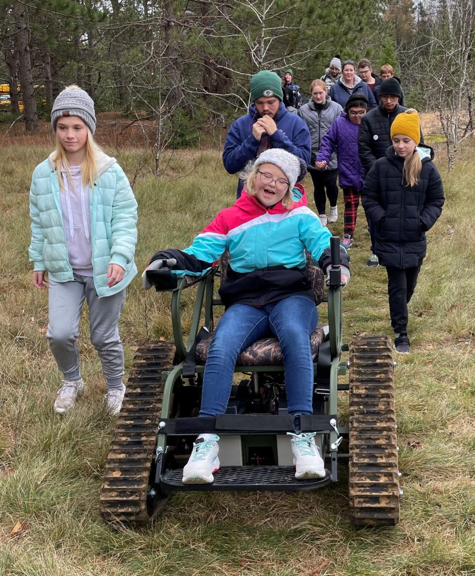 Led by a young person in an Action Trackchair, a group of children hikes the Family Discovery Trail at The Ridges Sanctuary in Baileys Harbor last November during a trial run for the all-terrain wheelchair. The nature preserve now has a Trackchair and is making it available for free to people with mobility issues so they can go out and enjoy nature, as is Peninsula State Park with its newly acquired Trackchair.