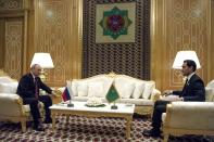 Russian President Vladimir Putin, left, and Turkmenistan's President Serdar Berdymukhamedov, 40-year old son of former Turkmenistan President Gurbanguly Berdimuhamedov, talk to each other during their meeting on the sideline of the summit of Caspian Sea littoral states in Ashgabat, Turkmenistan, Wednesday, June 29, 2022. (Mikhail Klimentyev, Sputnik, Kremlin Pool Photo via AP)