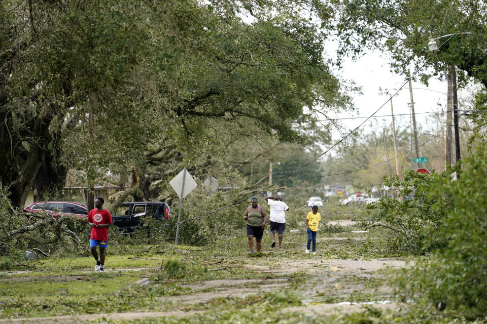 People survey the damage to their neighborhood on Thursday, Aug. 27, 2020, in Lake Charles, La., in the aftermath of Hurricane Laura. (AP Photo/Gerald Herbert)