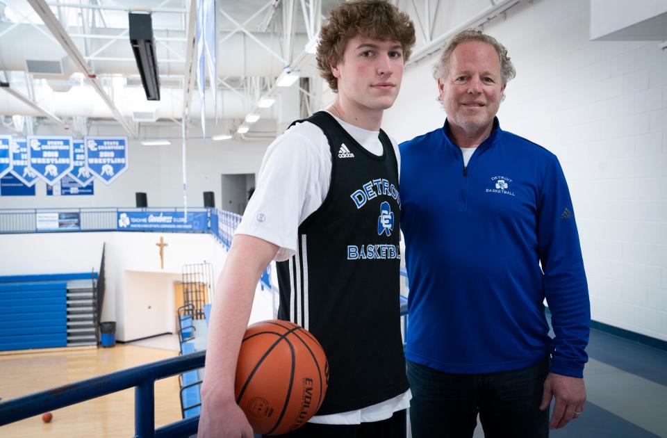 TJ Nadeau, 18, of South Lyon, left, poses with this dad Todd Nadeau, 62, before he practices with his Novi Detroit Central Catholic basketball team on Monday, Jan. 15, 2024, at Catholic Central.
