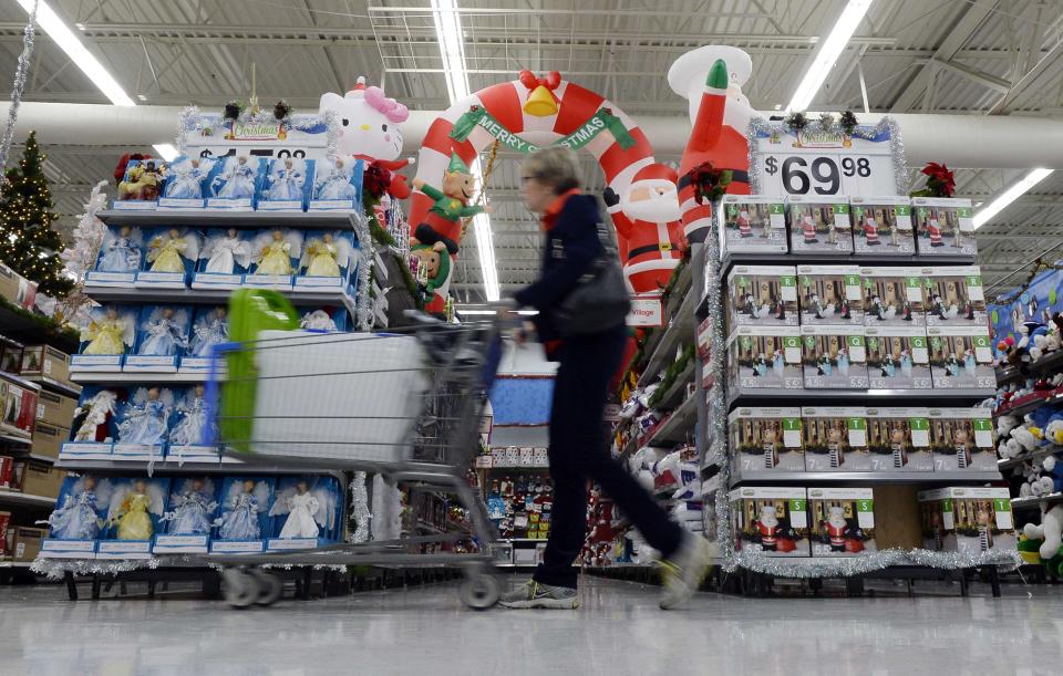 Customers shop for Christmas ornaments at the Wal-Mart Supercenter in the Porter Ranch section of Los Angeles November 26, 2013. This year, Black Friday starts earlier than ever, with some retailers, including Wal-Mart, opening early on Thanksgiving evening. About 140 million people were expected to shop over the four-day weekend, according to the National Retail Federation. REUTERS/Kevork Djansezian (UNITED STATES - Tags: BUSINESS ANNIVERSARY)