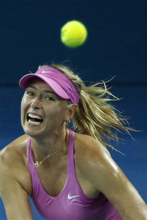 Maria Sharapova of Russia eyes the ball during her women's singles semi-finals match against Serena Williams of the U.S. at the Brisbane International tennis tournament January 3, 2014. REUTERS/Jason Reed