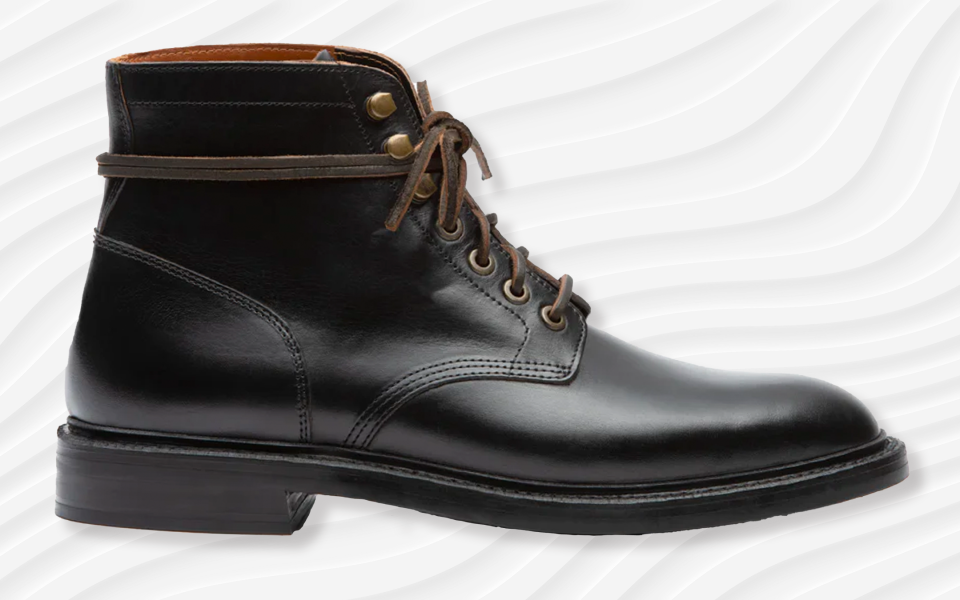 the grant stone diesel boot in black with a rubber sole against a wavy white background