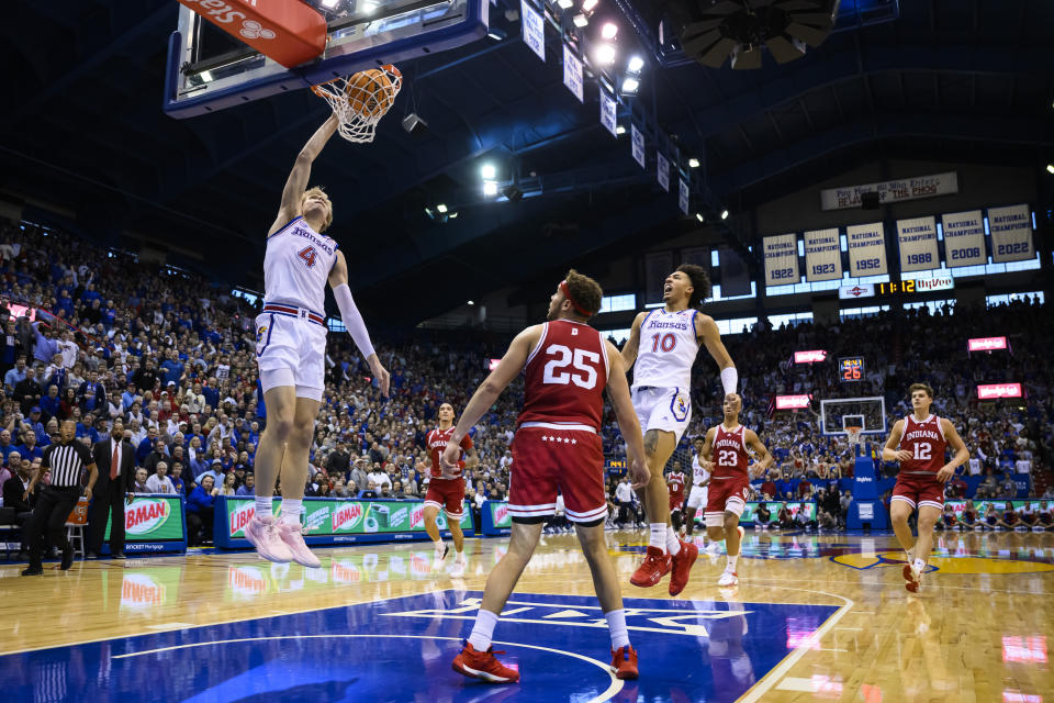 Kansas guard Gradey Dick (4) goes up for a dunk against Indiana forward Race Thompson (25) as teammate Kansas forward Jalen Wilson (10) cheers him on during the first half of an NCAA college basketball game in Lawrence, Kan., Saturday, Dec. 17, 2022. (AP Photo/Reed Hoffmann)