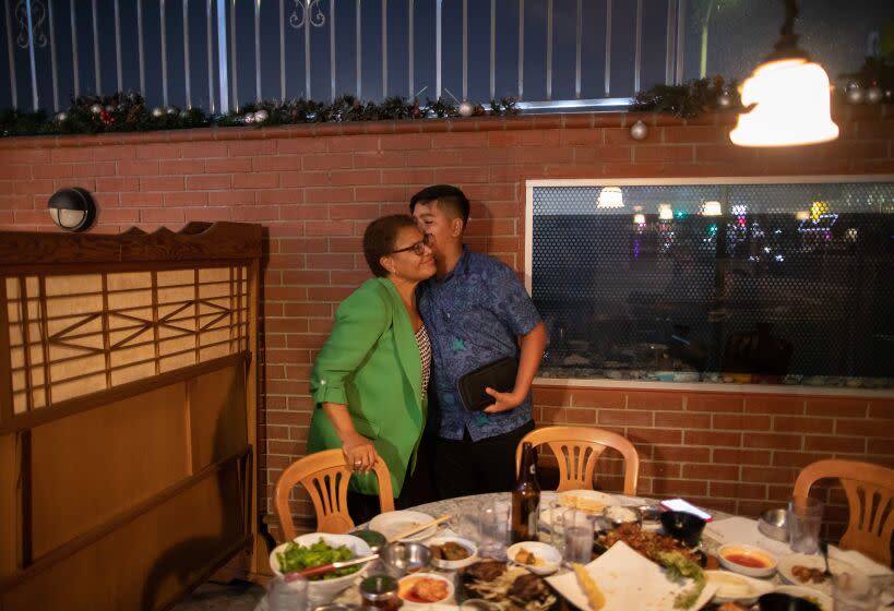 LOS ANGELES, CA - OCTOBER 08: Michael Pitpitan, 13, kisses his grandmother, Congresswoman Karen Bass, following a family dinner. Bass is running against businessman Rick Caruso for mayor of Los Angeles. Photographed on Saturday, Oct. 8, 2022 in Los Angeles, CA. (Myung J. Chun / Los Angeles Times)