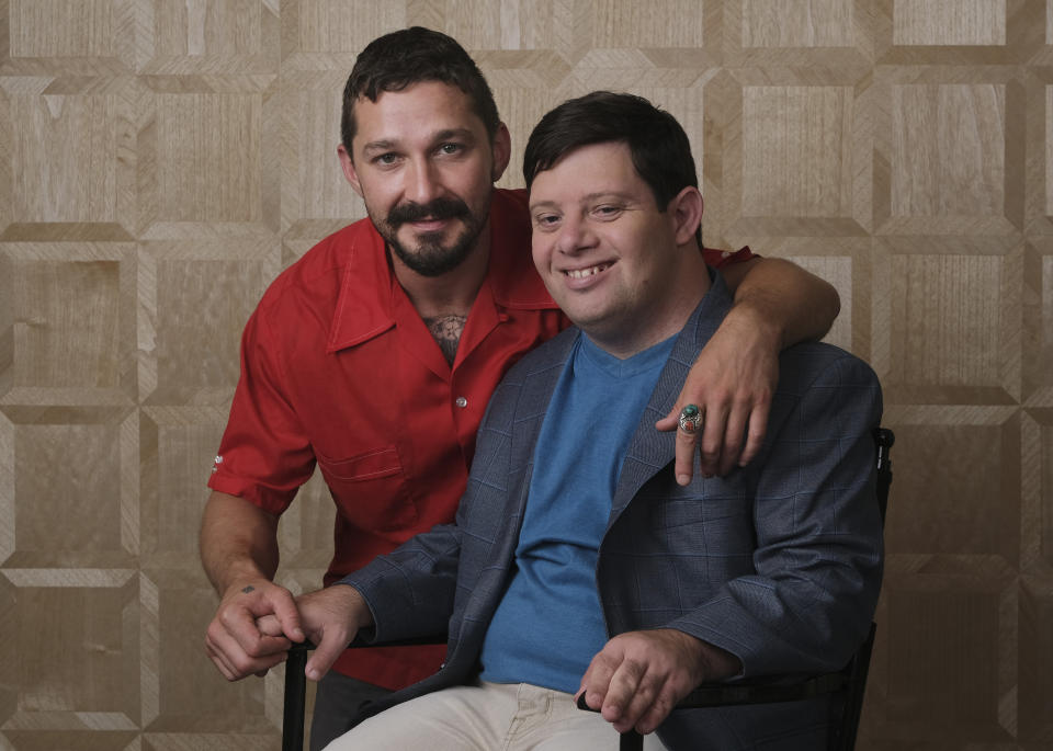 In this Friday, Aug. 2, 2019 photo, Shia LaBeouf, left, and Zack Gottsagen, cast members in the film "The Peanut Butter Falcon," pose together for a portrait at the London West Hollywood, in West Hollywood, Calif. The movie opens in the U.S. on Aug. 9. (Photo by Chris Pizzello/Invision/AP)