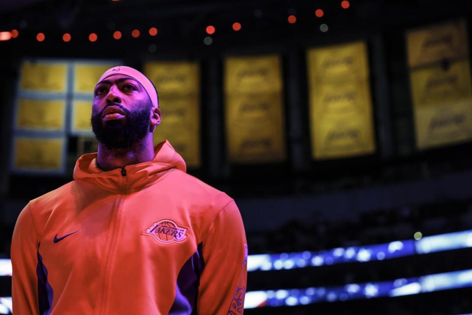 Anthony Davis listens to the national anthem.