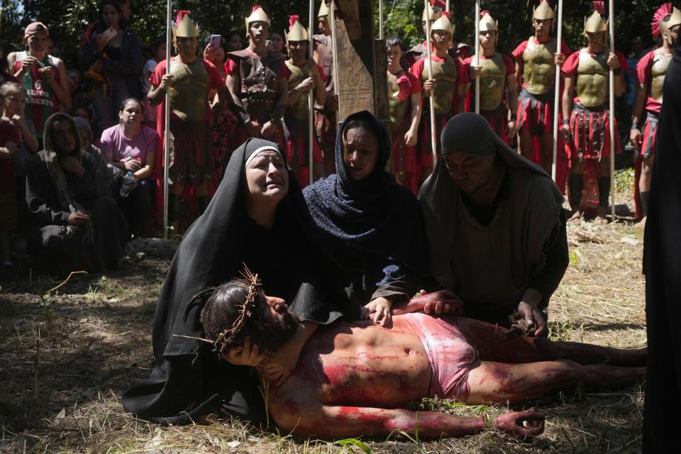 Actors perform in a Way of the Cross reenactment as part of Holy Week celebrations, in Atyra, Paraguay, Friday, March 29, 2024. Holy Week commemorates the last week of Jesus' earthly life which culminates with his crucifixion on Good Friday and his resurrection on Easter Sunday. (AP Photo/Jorge Saenz)