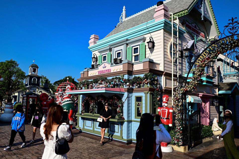 A woman (C) poses for photographs at Chocolate Ville, a European village-themed open-air restaurant, on New Years day in Bangkok on January 1, 2023. (Photo by MANAN VATSYAYANA / AFP) (Photo by MANAN VATSYAYANA/AFP via Getty Images)