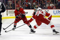 Carolina Hurricanes' Seth Jarvis has the puck tipped by Detroit Red Wings' Moritz Seider during the second period of an NHL hockey game in Raleigh, N.C., Thursday, March 28, 2024. (AP Photo/Karl B DeBlaker)