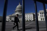 FILE PHOTO: A man walks past the U.S. Capitol building as a government shutdown looms in Washington