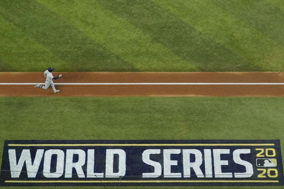 Tampa Bay Rays' Brandon Lowe rounds the bases after hitting a home run against the Los Angeles Dodgers during the first inning in Game 2 of the baseball World Series Wednesday, Oct. 21, 2020, in Arlington, Texas. (AP Photo/David J. Phillip)