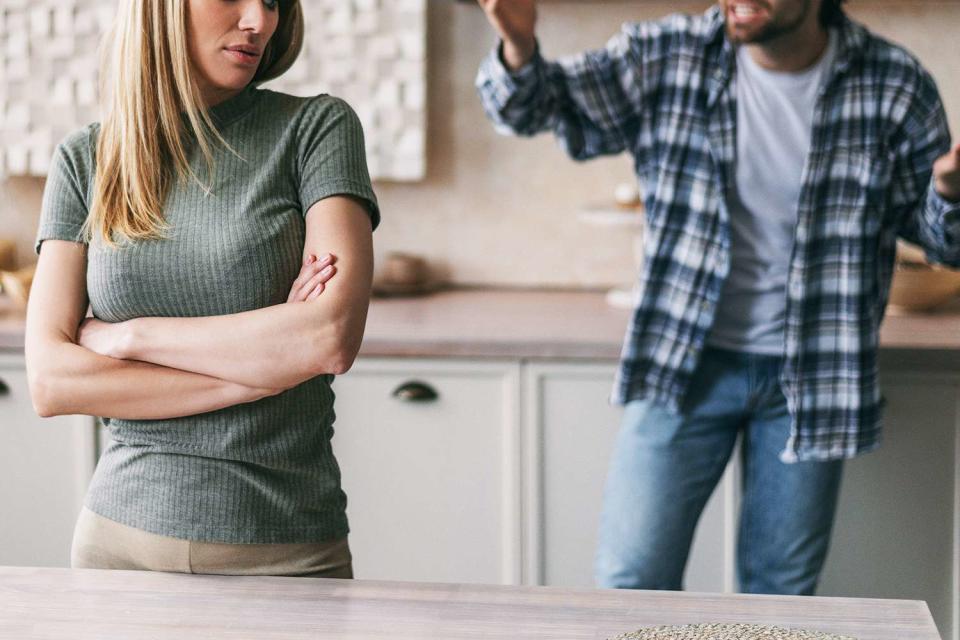 <p>Prostock-Studio/Getty</p> woman and man in fight in kitchen