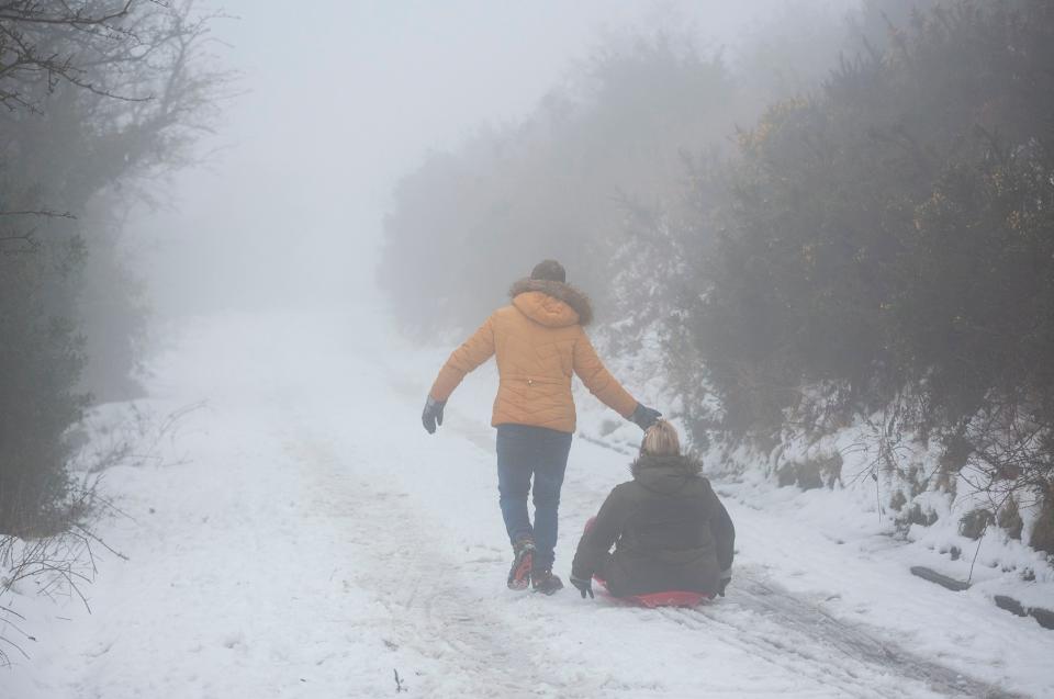 The earlier bad weather was not bad news for everyone though, including this sledding couple in West Yorkshire (Rex)