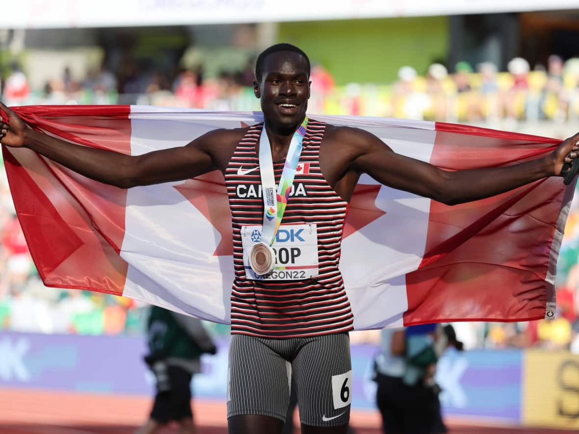 Canada's Marco Arop celebrates after capturing bronze in the men's 800-metre final at the World Athletics Championships in Eugene, Ore., on Saturday. (Lucy Nicholson/Reuters - image credit)